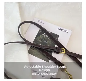 Detail of adjustable dark brown leather strap with premium gold buckles and stitching