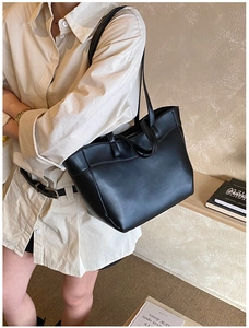 Close-up of minimalist black leather tote bag with secure zipper closure for daily commute