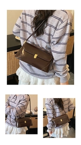 Detailed view of deep brown vintage baguette bag with gold buckle and smooth leather finish