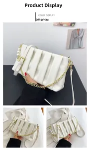 Detail of off-white pleated shoulder bag with gold chain and pearl charm decoration