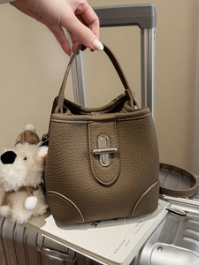 Dark brown lychee texture leather bucket bag with silver clasp and shoulder strap