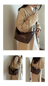 Large brown leather hobo bag styled with a trench coat for a casual chic fashion look