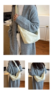 Detail view of cream-colored leather hobo bag showing stitching and soft texture
