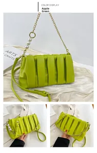 Detail of apple green pleated handbag with large white pearls and gold chain strap