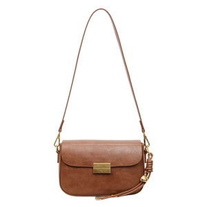 Detail of vintage brown shoulder bag with golden buckle and decorative small bell