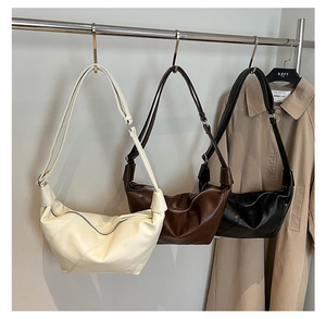 Three half-moon pleated leather crossbody bags in beige, dark brown, and black colors