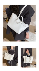 Detail of white leather tote bag with dual handles and logo for office commuting