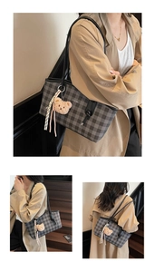 Detail of grey checkerboard tote bag with plush bear charm and brand logo branding
