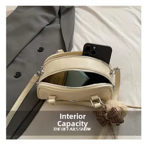 Internal capacity of beige crossbody bag showing space for phone and cosmetics