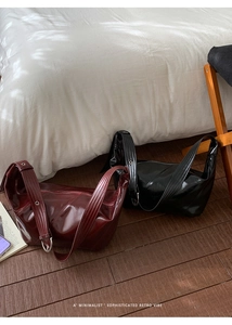 Retro high-shine leather hobo bags in deep burgundy and black with adjustable straps