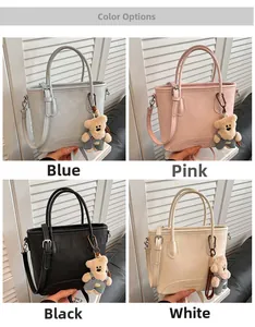 Detail view of four casual bucket bags in blue, pink, black, and white with bear charms