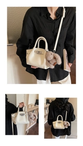 Detailed views of beige pleated crossbody bag with plush bunny charm and silver buckle