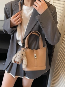 Chic camel leather bucket bag with metal turn-lock and cute rabbit charm for women