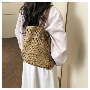 Detail of hollow-out woven texture and leather straps on the summer tote bag