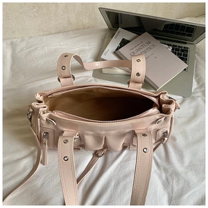 Internal view of pink multi-pocket handbag with brown lining and spacious compartments