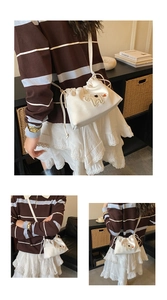 Detail of white drawstring crossbody bag featuring a cute plush animal embroidery