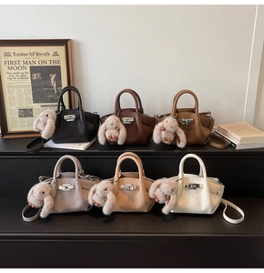 Detail view of mini bucket bags in six colors with pebble texture and plush charms