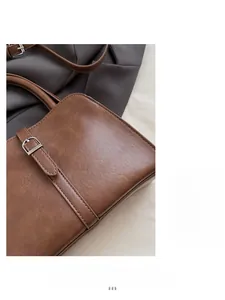 Close-up of brown textured leather handbag with silver hardware and neat stitching detail