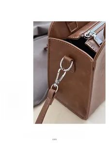 Detailed close-up of premium silver-toned hardware and brown faux leather texture