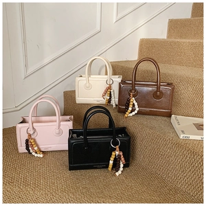 Chic small square handbags in pink, cream, brown, and black with beaded charms