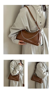 Dettaglio borsa sottobraccio in pelle caramello vintage con catena d'argento e tracolla