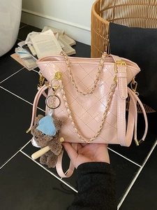 Pink quilted patent leather bucket bag with gold chain handle and bear charm decoration