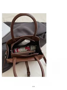 Interior view showing the large capacity of the brown tote bag with daily essentials