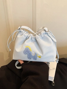 Light blue ruched cloud crossbody bag with an embroidered pony motif and drawstring closure