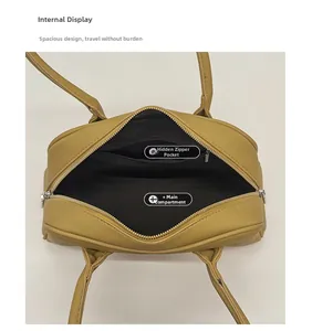 Internal view of litchi texture boston bag with main compartment and zipper pocket