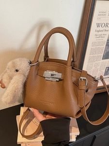 Brown leather tote bag with pleated texture, silver twist lock and plush rabbit charm