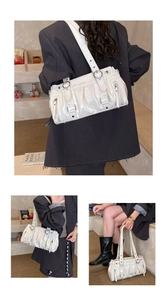 Detailed views of a white pleated patent leather shoulder bag with silver hardware