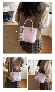Close-up of the embossed LALAGIE BAGS logo on the pink faux leather tote with bear charm