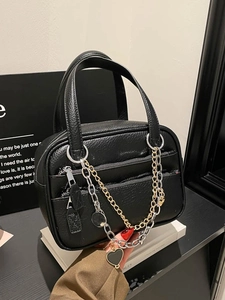 Chic black litchi grain Boston bag with dual-tone chain and heart charm detail