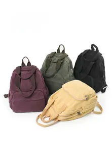 Group view showing multiple colors of canvas backpacks with zipper pockets and side pouches