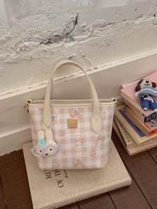 Pink checkered underarm bag with cute cartoon prints and a plush rabbit pendant charm
