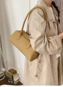 Retro mustard yellow leather shoulder bag with sleek straps and litchi texture
