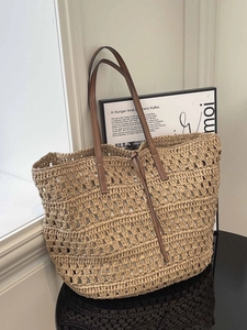 Large woven hollow tote bag with brown leather straps for beach and commute