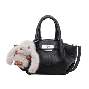Black pebbled leather bucket bag with silver twist lock and plush rabbit charm