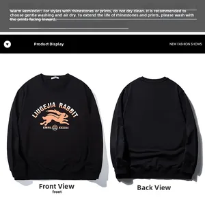Detail view of black sweatshirt showing orange rabbit print and washing instructions