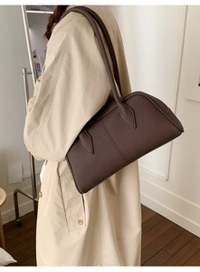 Deep brown pebble leather shoulder bag styled with a beige trench coat for a chic look