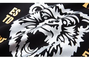 Close-up of silver rhino rhinestone print and gold ES TD letters on black hoodie