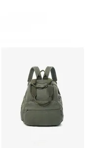 Front view of a dark olive canvas backpack with durable fabric straps and zippered pocket