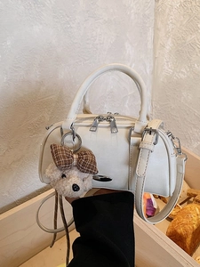 Creamy white Boston handbag for women with teddy bear charm and adjustable strap