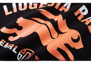 Detail showing the vibrant orange rabbit print and street style lettering on black knit fabric