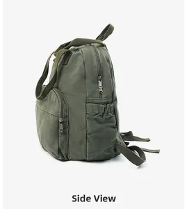 Side view of an army green canvas travel backpack showing the flexible side pocket and zippers