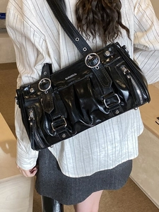Glossy black bowling-style shoulder bag with silver hardware and pleated details