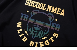 Détail d'un t-shirt style urbain avec ours coloré et impression graphique dorée