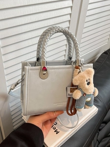 Chic light gray square tote bag with woven handles and a cute plush bear pendant accessory
