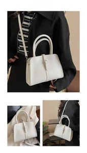 Detail of white PU leather square handbag with silver metal buckle and adjustable strap
