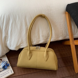 Detail of light yellow retro pillow bag showing lychee grain leather and silver zippers